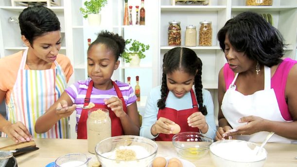 black women cooking with girls.jpg